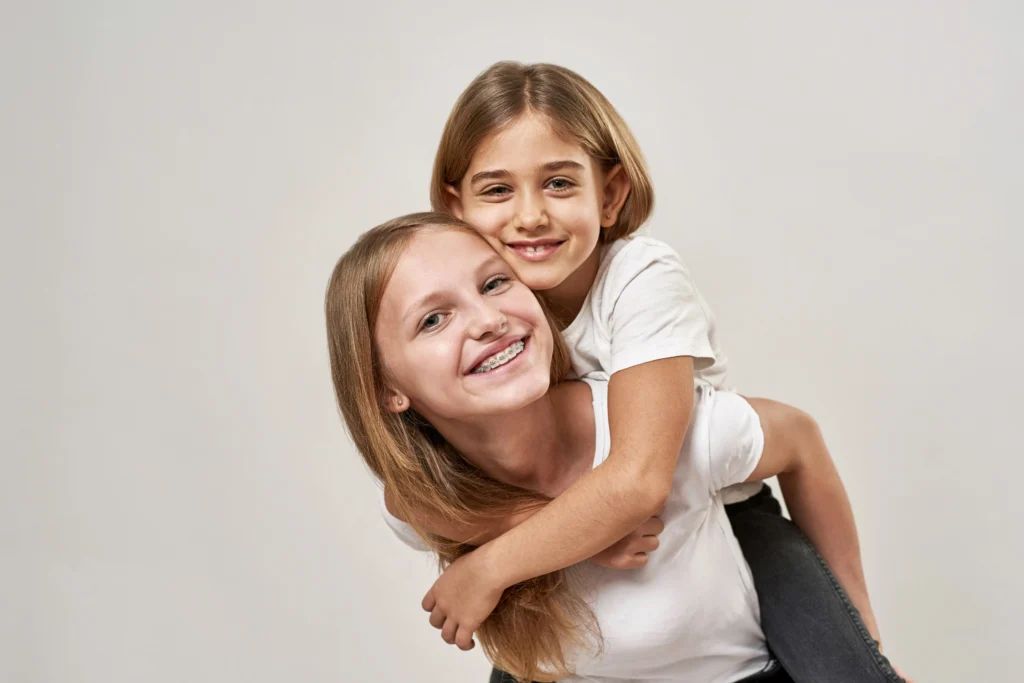 Two young girls smiling.